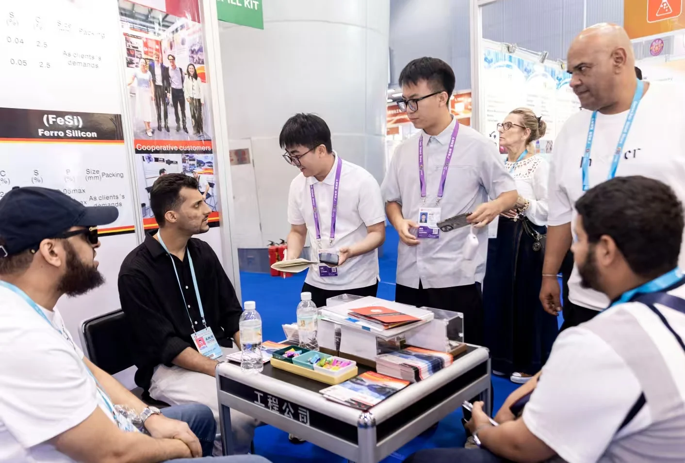 Panson team members and visitors around the exhibition table