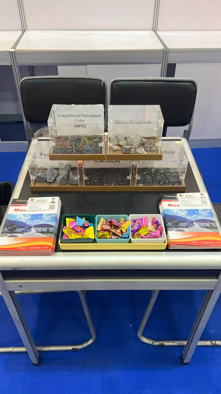 Physical material samples and product literature displayed on the Panson booth table