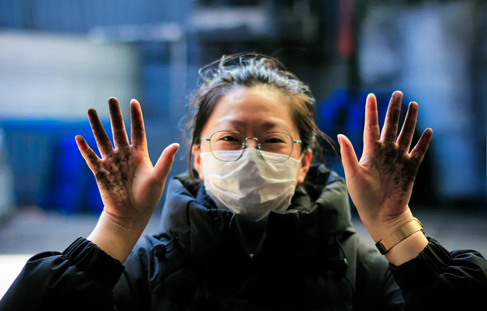 Production staff member showing hands-on quality inspection work